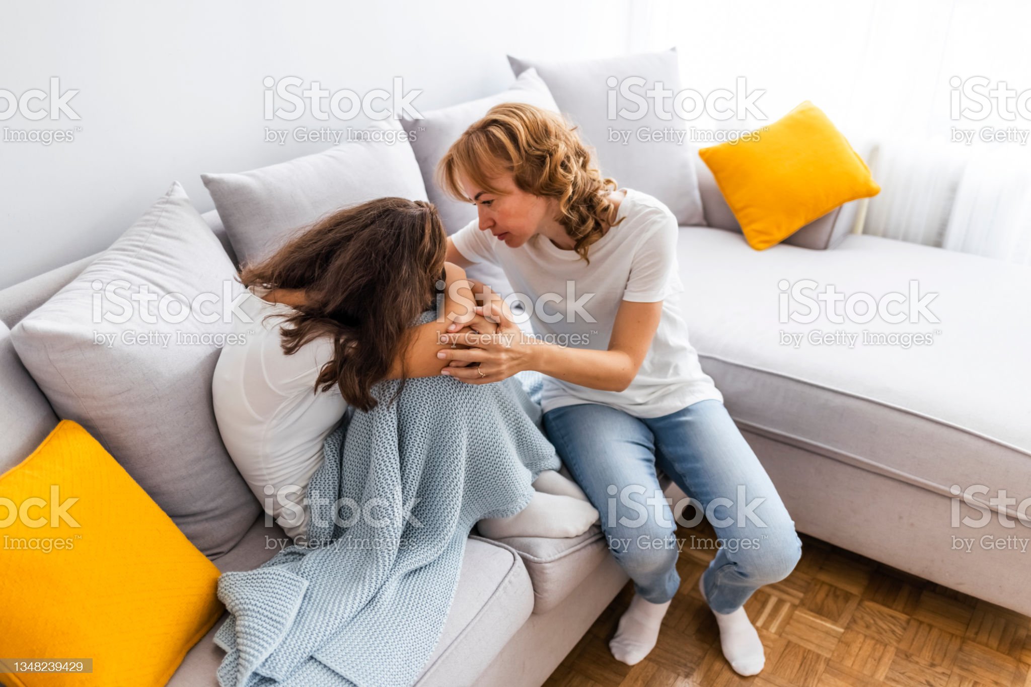 How to Explain Complex PTSD to Loved Ones Caring mature mother comforting upset depressed teenage daughter at home.